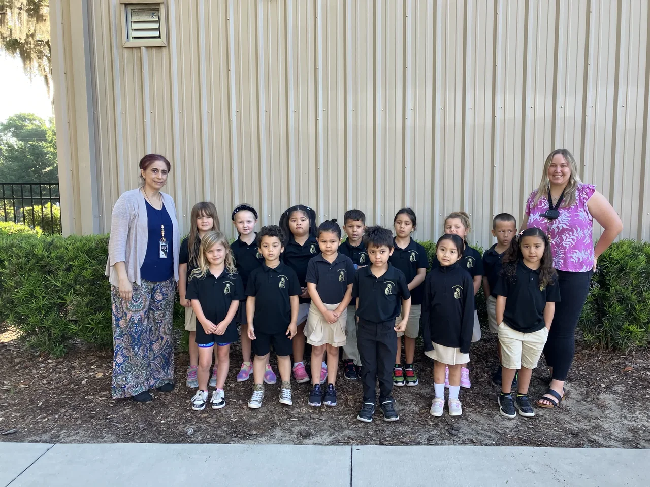 Students and teachers outside a school building