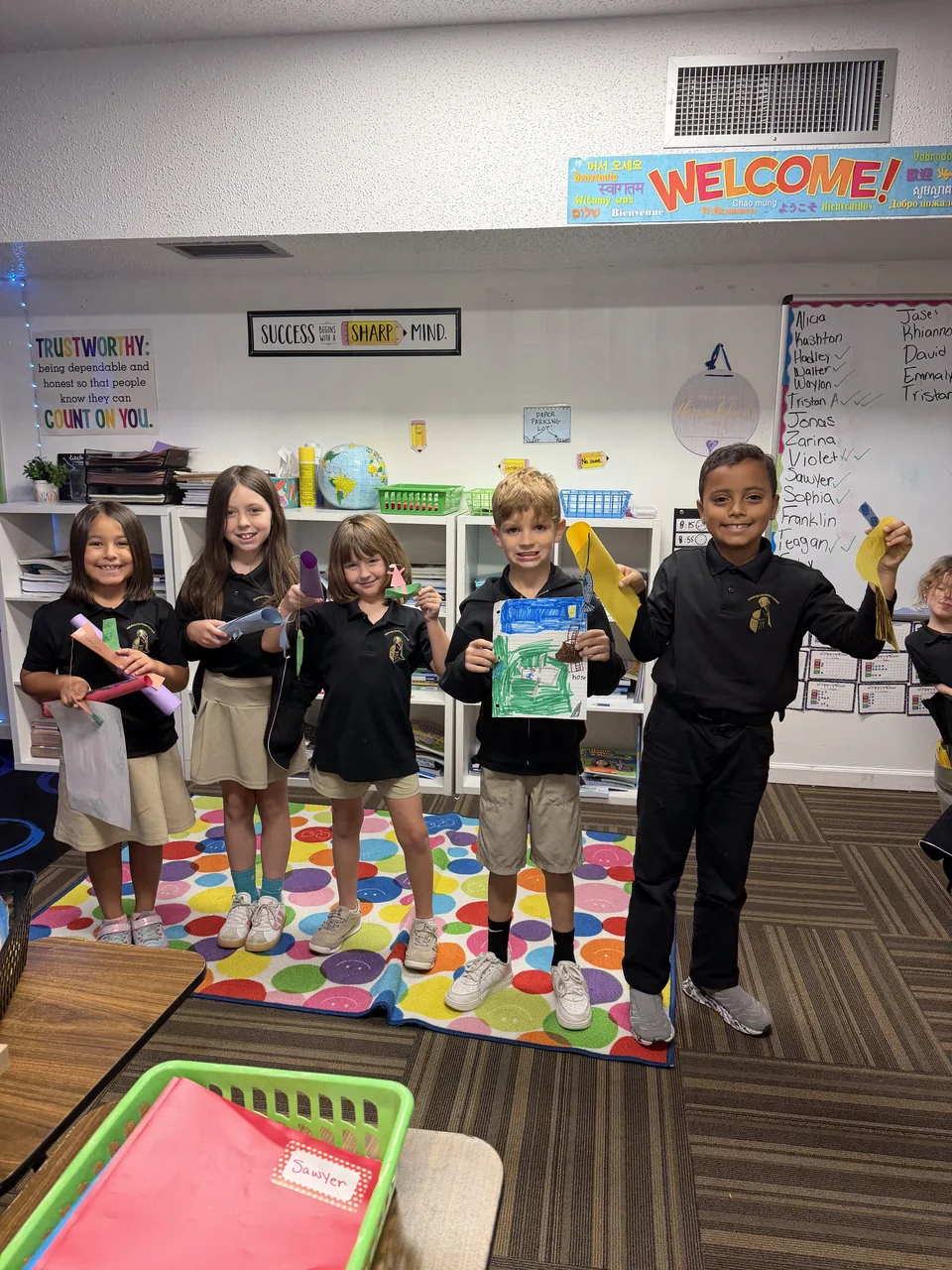 Students standing with classroom work