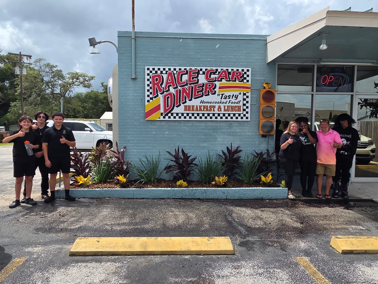 Group visiting a local business sign