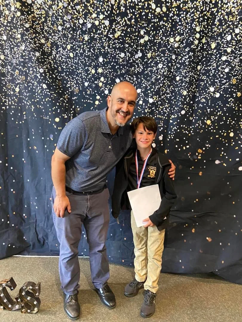 Graduate with an adult at a school celebration
